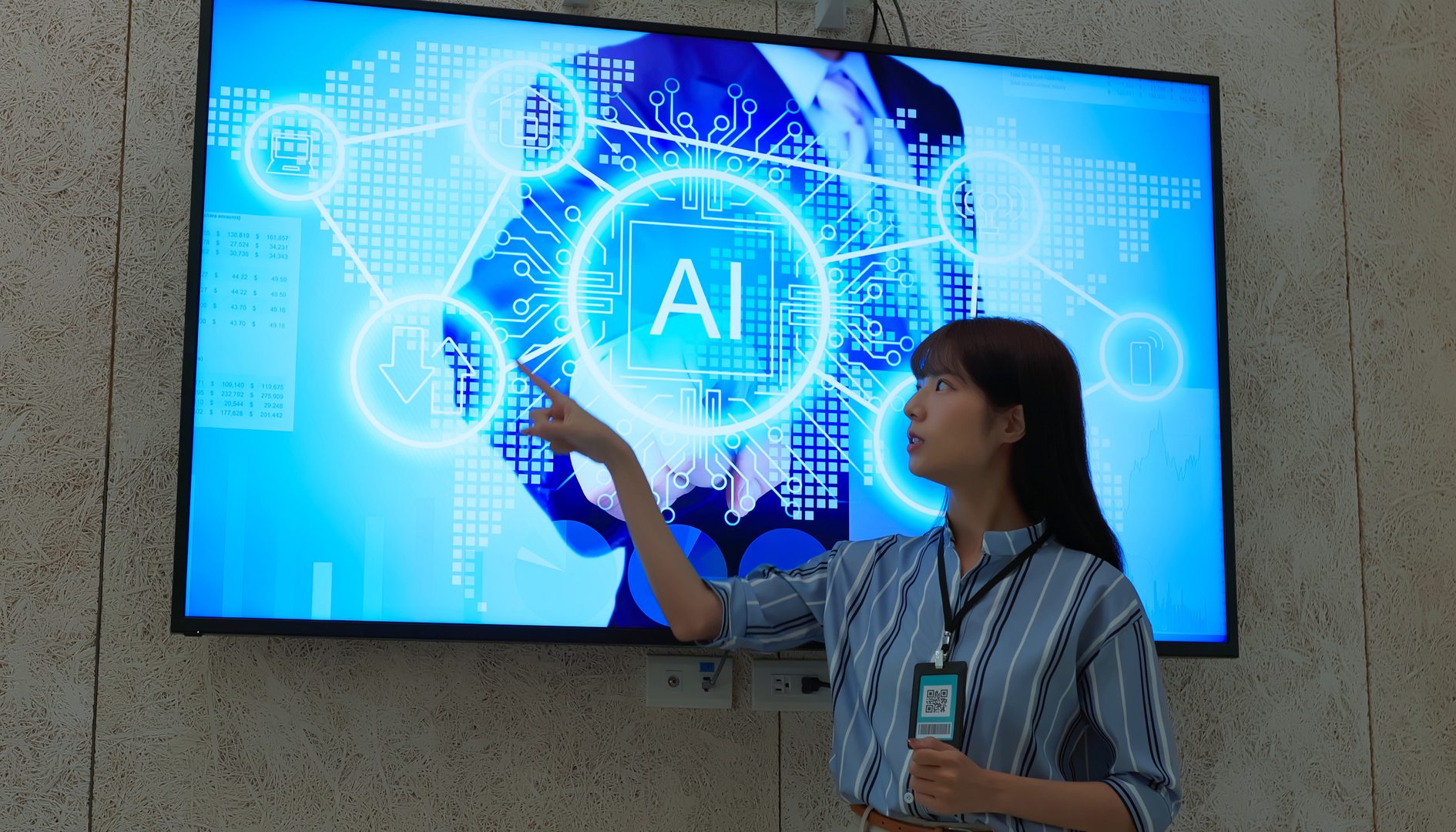 Person presenting AI concept on large screen.