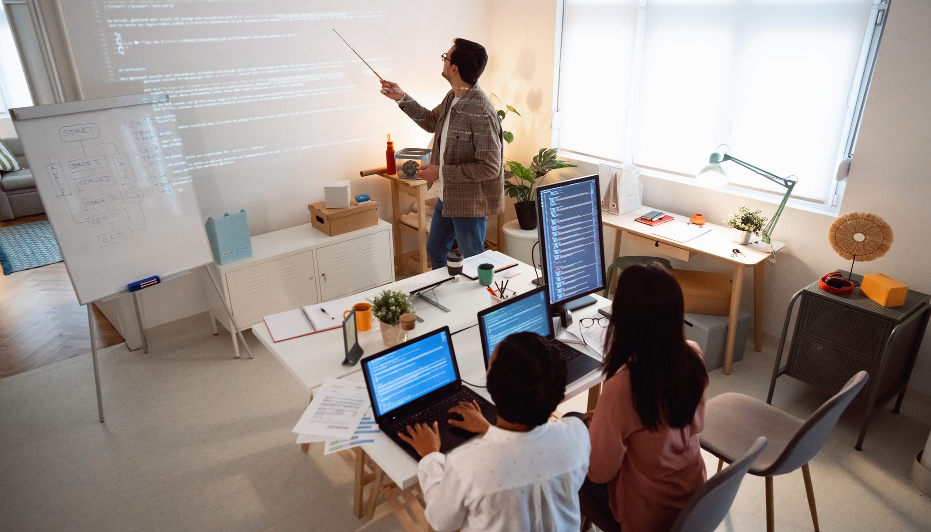 People in a classroom learning computer programming.